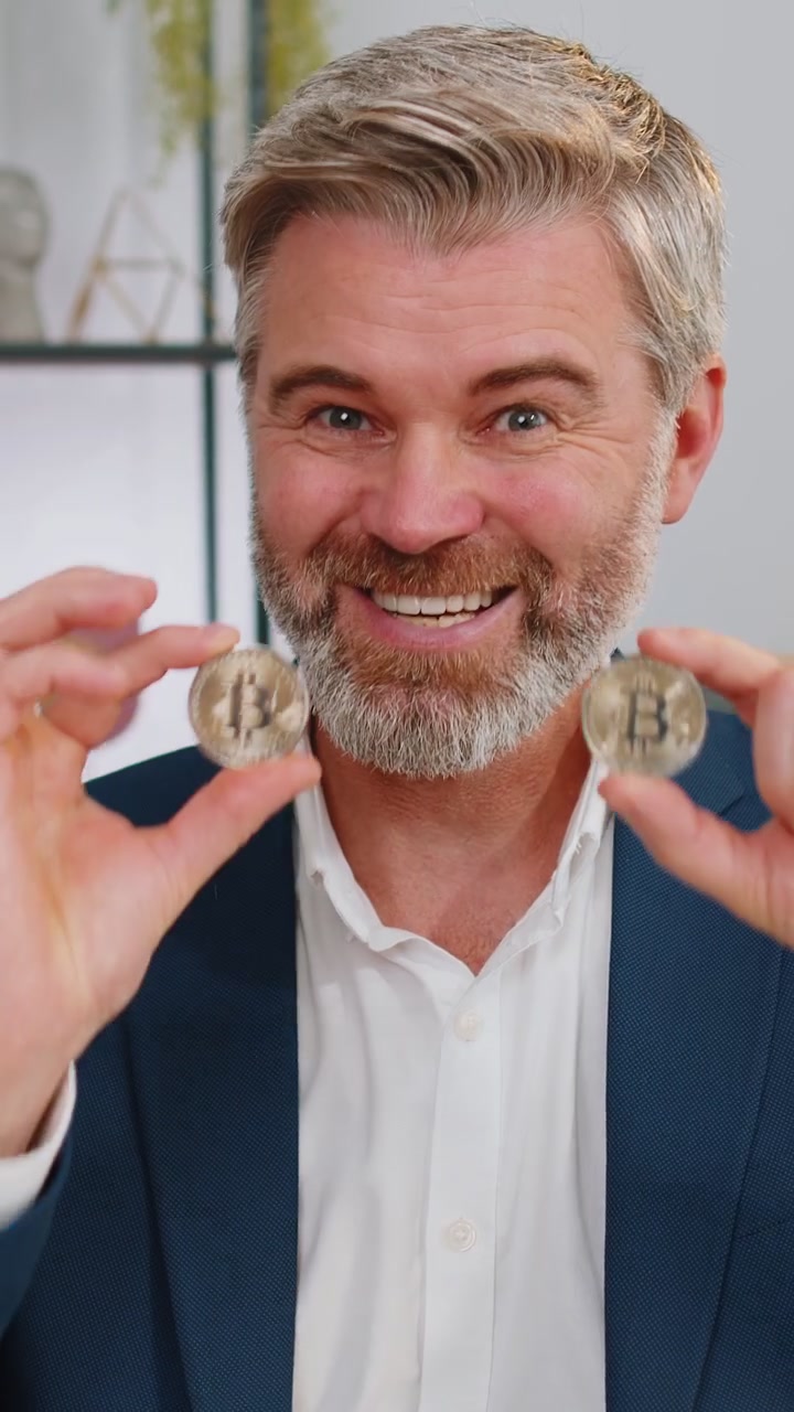 Businessman stock trader earning count bitcoins after online monitoring trading operations at office