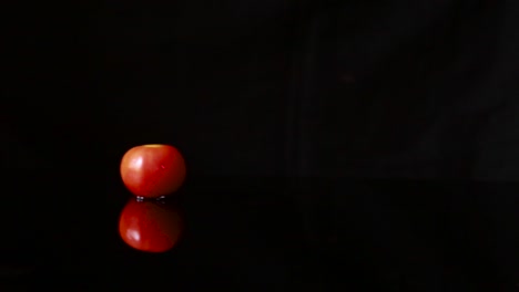 tomatoes water splash in super slow motion on black background