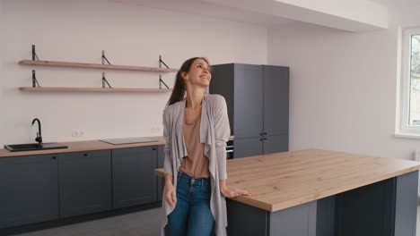 Amazed-young-caucasian-woman-in-her-new-empty-house.