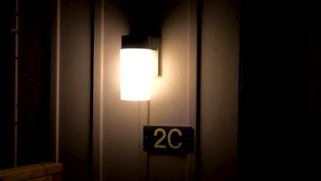 house number 2c under a light at night