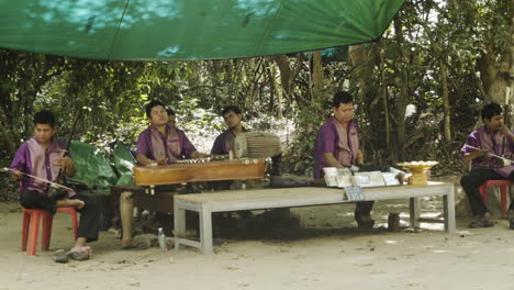 group of blind cambodian musicians playing on their musical instrument.