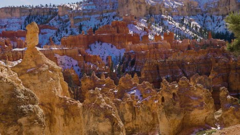 girl woman hiking with red rocks formation and snow near bryce canyon in southern utah