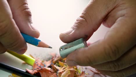 Footage-of-hands-slowly-sharpening-a-pencil-and-some-coloured-pencils-with-a-Wedge-Pencil-Sharpener