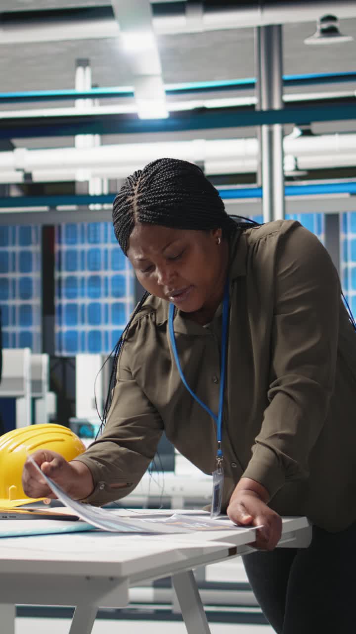 Vertical Video Woman industrial expert performing quality control on solar power production