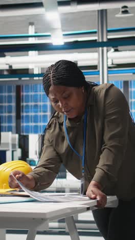 vertical video woman industrial expert performing quality control on solar power production