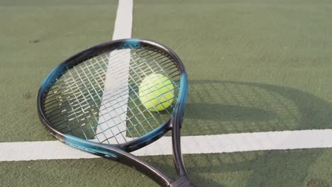 video of tennis racket and ball lying on tennis court