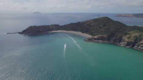 speedboat cruising in the sea to the secret beach - butterfish bay in great keppel island, qld, australia