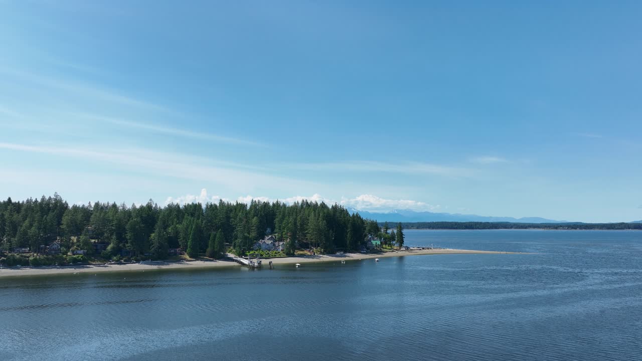 Aerial view pushing towards Herron Island's private beaches in the Puget Sound