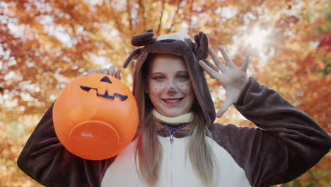 Portrait-of-a-child-in-a-deer-costume-with-a-basket-for-collecting-sweets.-Autumn-holidays---Halloween