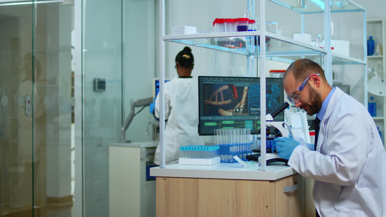 Scientist using microscope cheching virus development