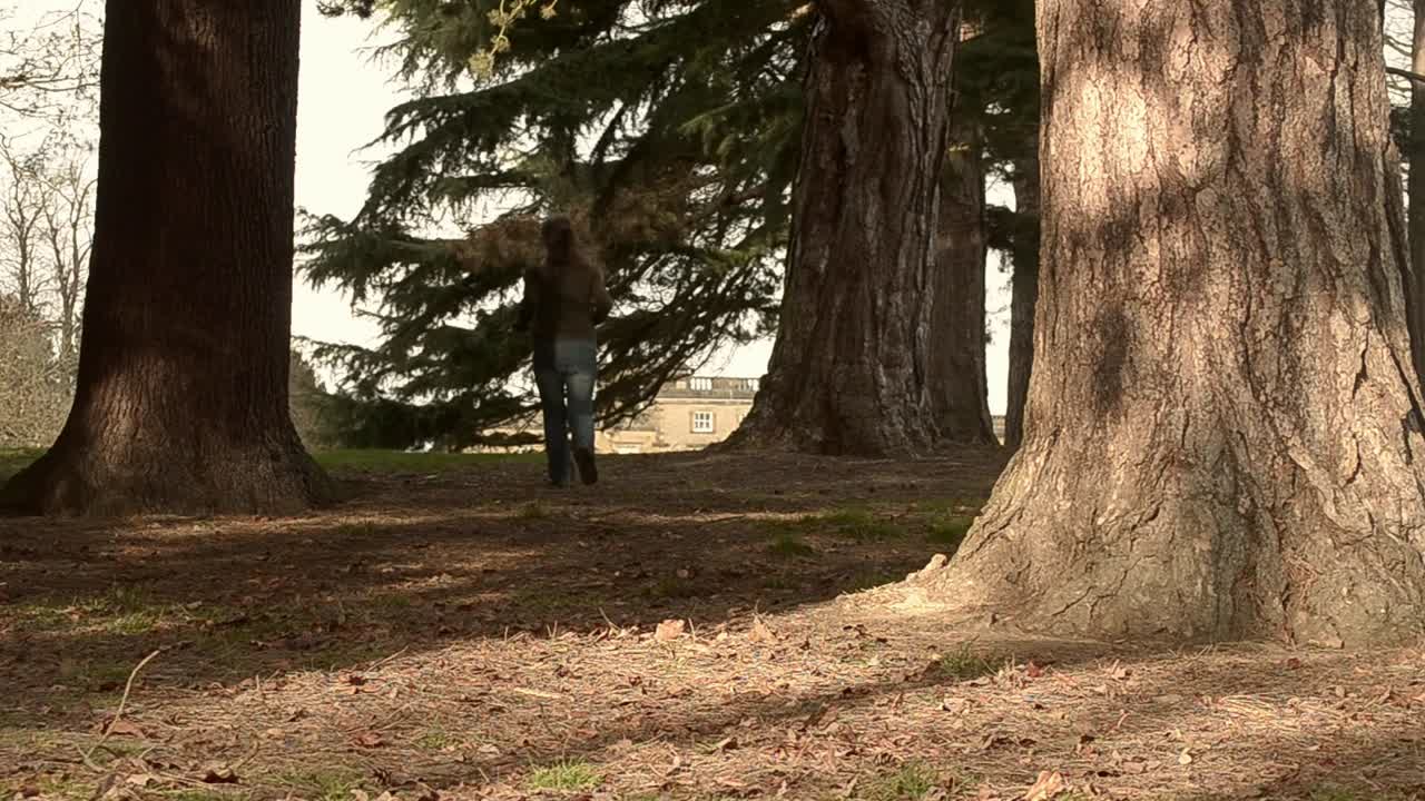 Woman running into woodland park