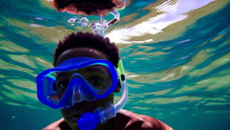 young boy snorkeling underwater