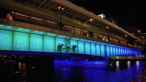osaka temmabashi bridge at night illuminated for river cruise, japan
