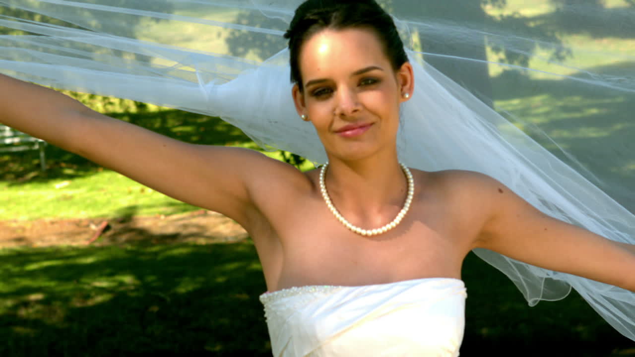 Sposa in posa per la fotocamera nel parco