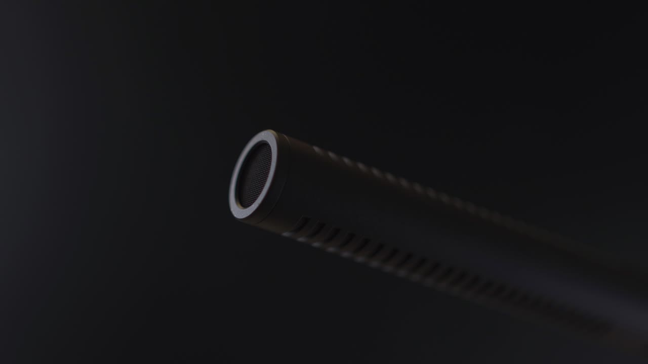 Panning over on microphone in a studio or dark room - close up
