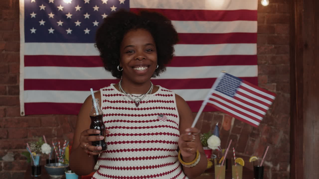 Woman Celebrating the 4th of July with a Soda and Flag