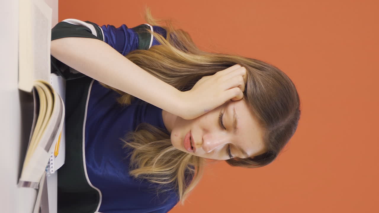 노트북 앞에서 잠들어 있는 젊은 여성의 수직 비디오입니다.