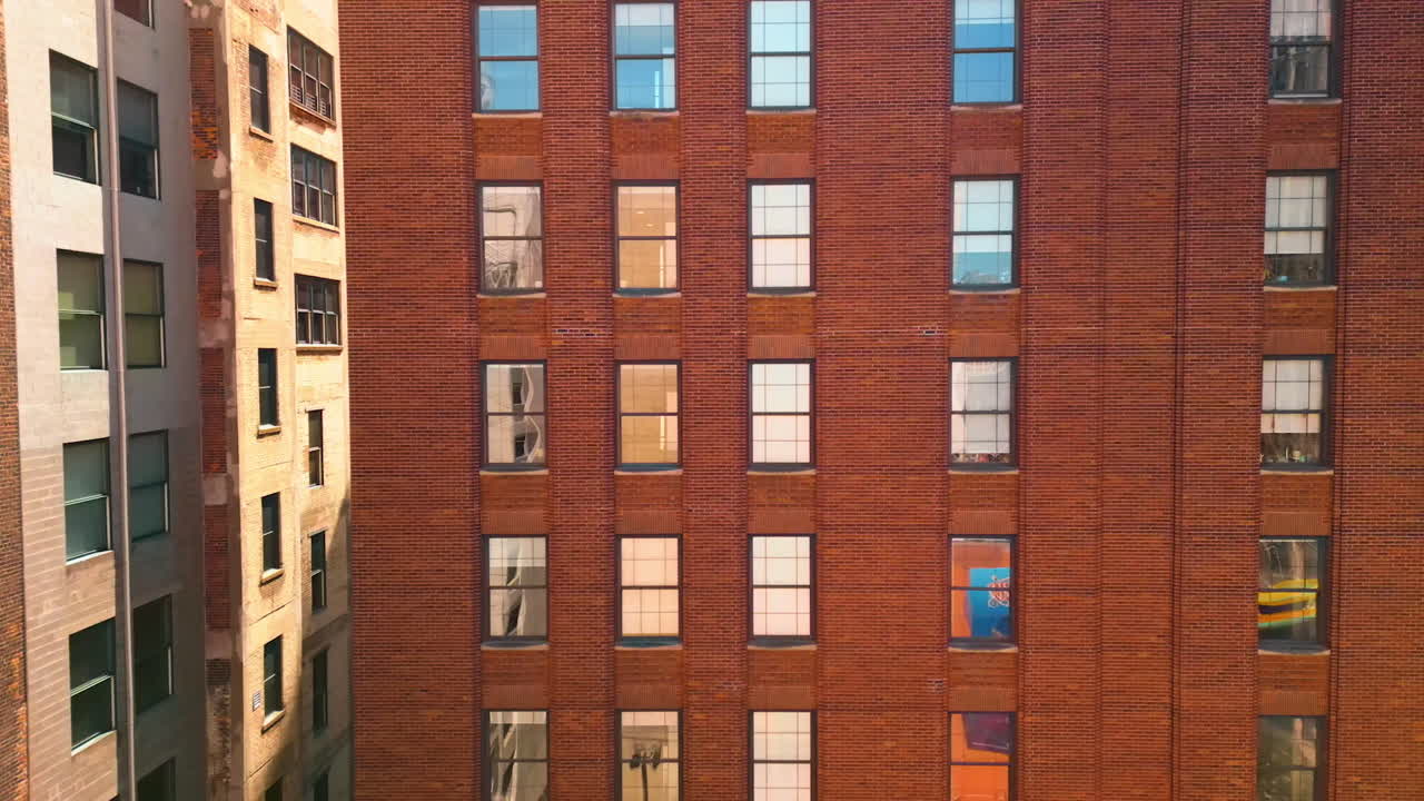 Footage at the facades of the high-rise red brick buildings. Old-style architecture of Detroit, Michigan, USA