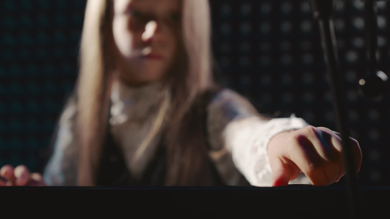 Kid meticulously adjusts sound of piano. Girl skillfully arranges setup of electric piano during vocal lesson. Student brings synthesizer to life