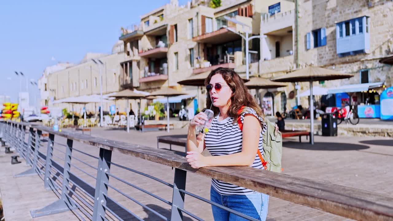 Woman Drinking Beverage While Exploring Old Jaffa Port