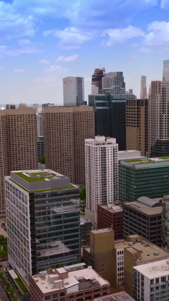 Chicago panoramic view on sunny midday. Impressive buildings towering over complicated road systems. Aerial perspective. Vertical video