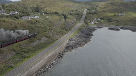 jacobite express train aerial track shot leaving mallaig station