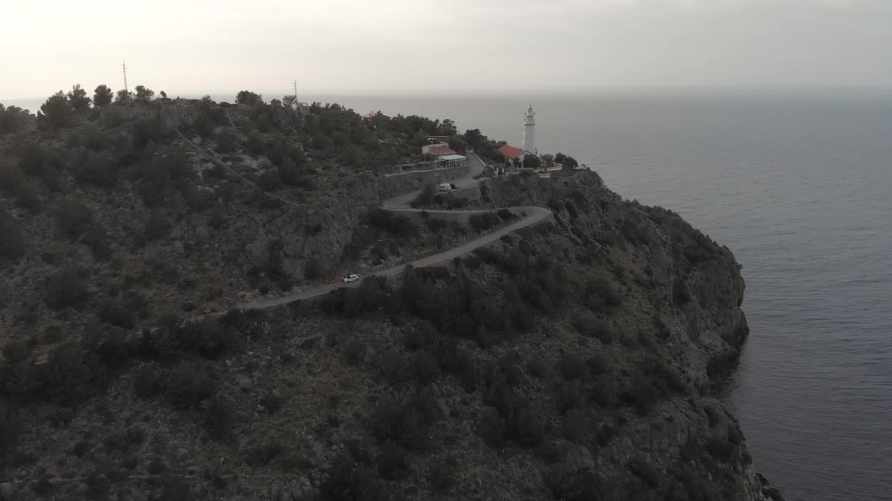 Aerial, rising, drone shot of the Far des Cap Gros lighthouse, near Port de Soller, in Mallorca, Spain - Black - white