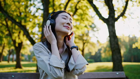 woman listening to music in the park