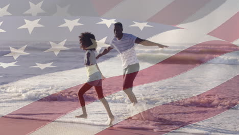 animation of flag of united states of america over african american father and daughter on beach