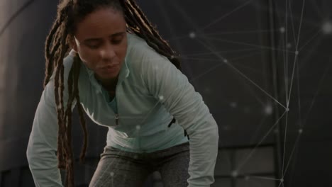 Network-of-connections-against-tired-african-american-fit-woman-taking-a-break-from-running