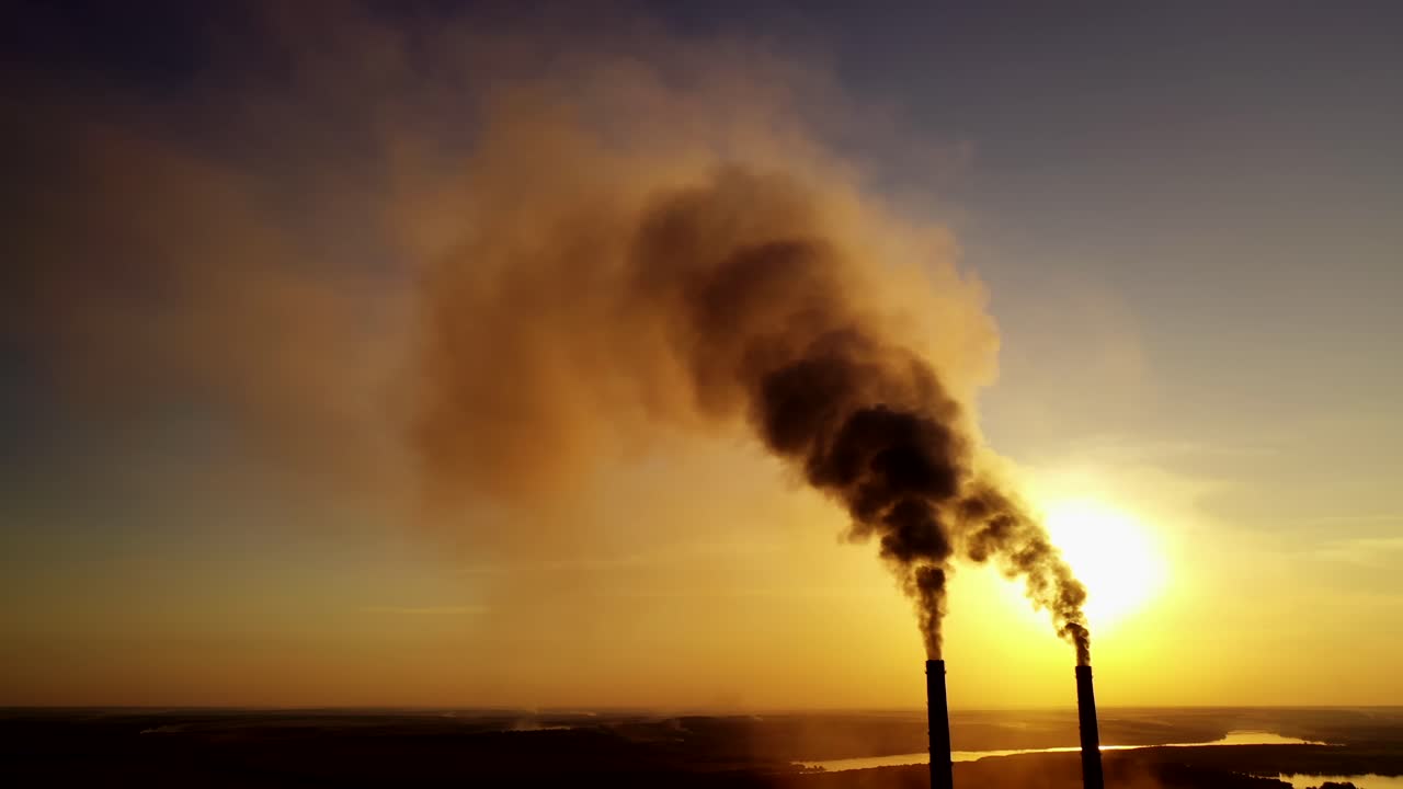 Smoking pipes of factory. Industrial chimneys with heavy smoke causing air pollution problem