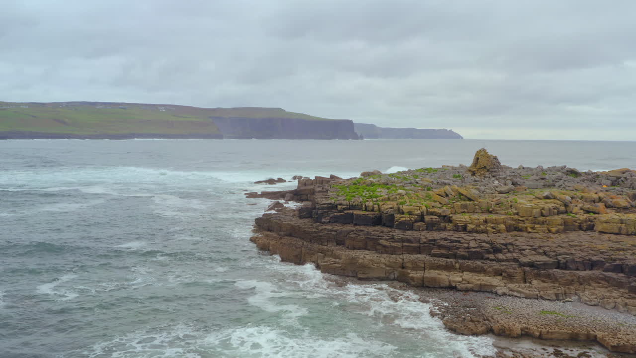 Aerial dolly featuring Crab Island and the Cliffs of Moher under a moody, overcast sky