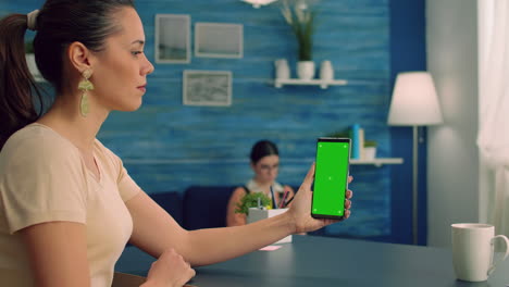 Business-woman-sitting-on-office-table-in-living-room-using-modern-phone