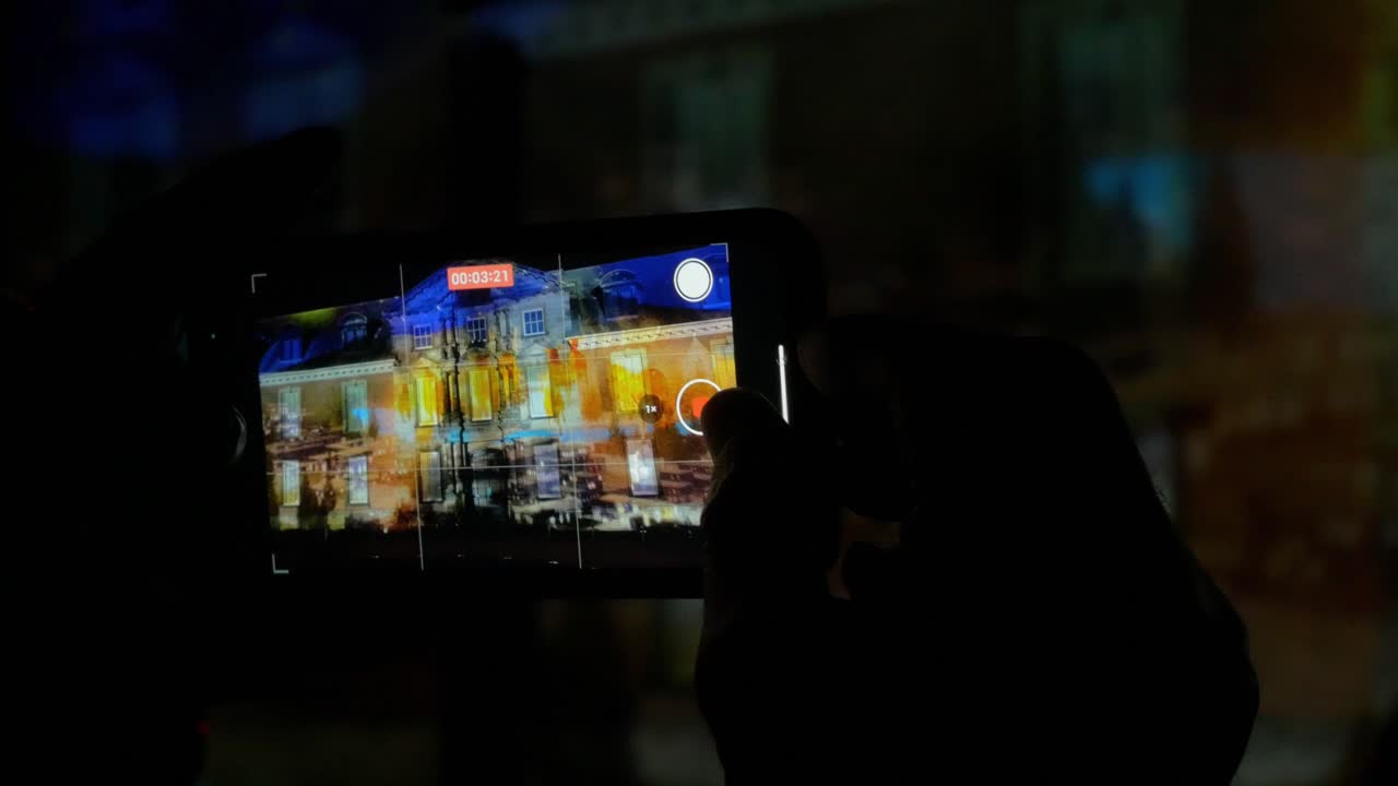 Phone recording projectiion video at night of light show at Christmas