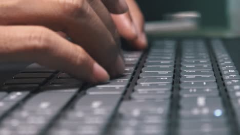 super close shot of female hands typing on a laptop computer