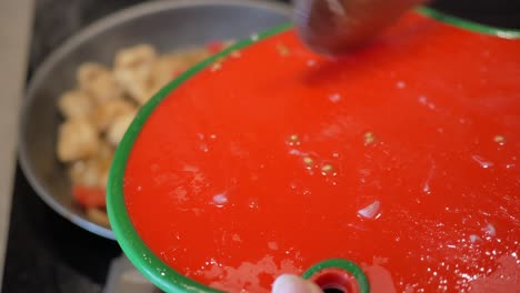 close up of chopped tomatoes on red cutting board