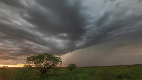 Dramatic-dark-clouds-over-trees-and-fields-with-lightening-bolts