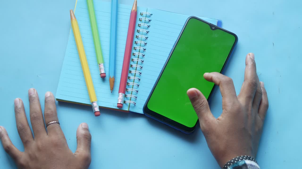 Smartphone and Pencils on Notebook