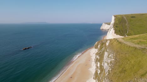 drone view of durdle door beach in dorset, england