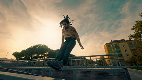 man jumping over a bridge at sunset