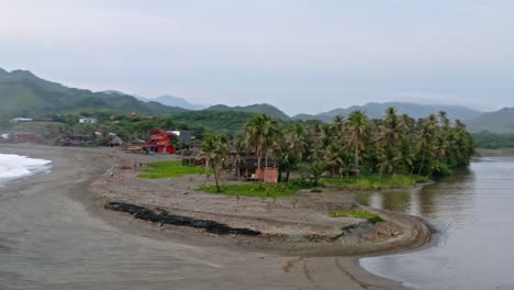 Aerial:-remote-Mexican-peninsula-beach-on-Pacific-coast,-freshwater-meets-sea