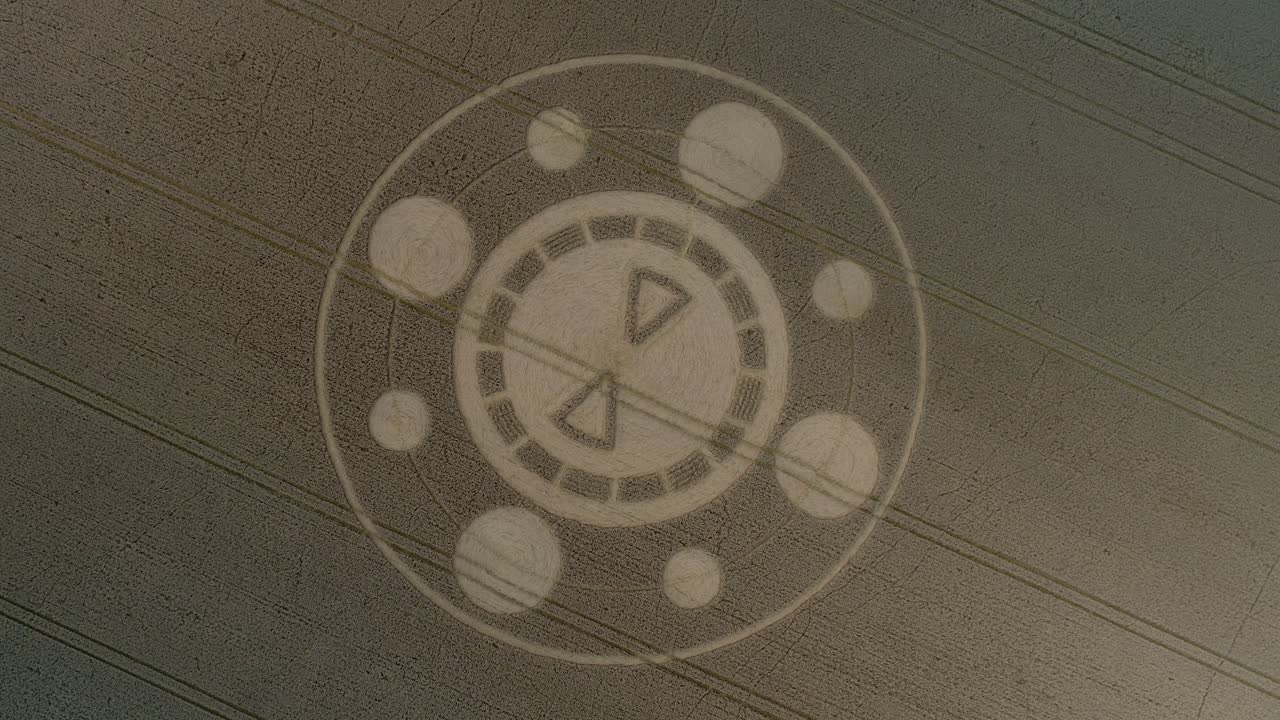 Swarraton barley field geometric crop circle pattern aerial descending birdseye drone view above Hampshire countryside