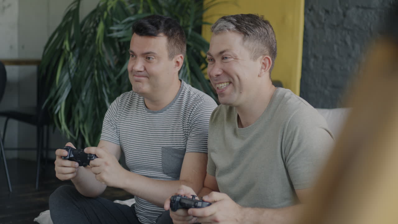 Two Friends Having Fun Gaming Together at Home