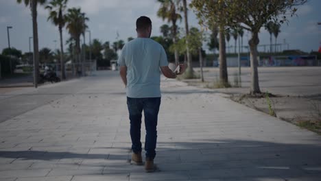 man walking with a book on a city street