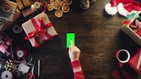 Top-view-woman-hands-using-touchscreen-smartphone-tablet-hand-gestures-green-screen-table-from-above---Red-Epic-Dragon