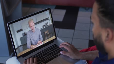 Afroamerikanischer-Geschäftsmann,-Der-Einen-Laptop-Nutzt-Und-Einen-Videoanruf-Mit-Einem-Männlichen-Kollegen-Führt