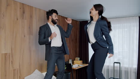 business couple celebrating in hotel room