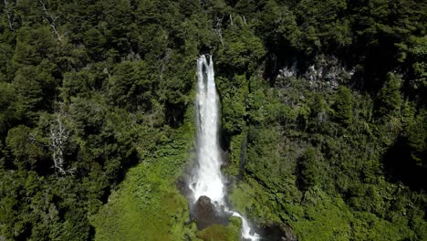 dolly in of the waterfall el salto el leon surrounded by vegetation and with a constant rainbow - crane shot