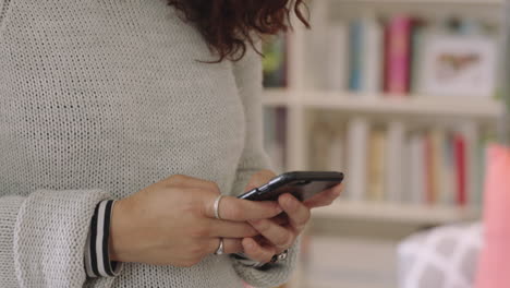 close-up-young-mixed-race-woman-using-smartphone-texting-messaging-enjoying-mobile-phone-social-media-communication-in-home-study-library