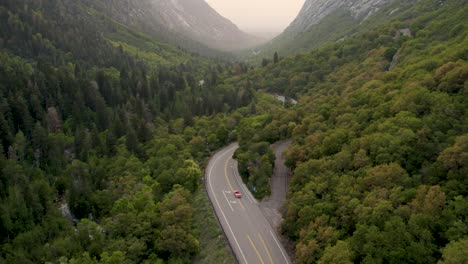 car on epic road trip in beautiful mountain valley in utah - aerial drone